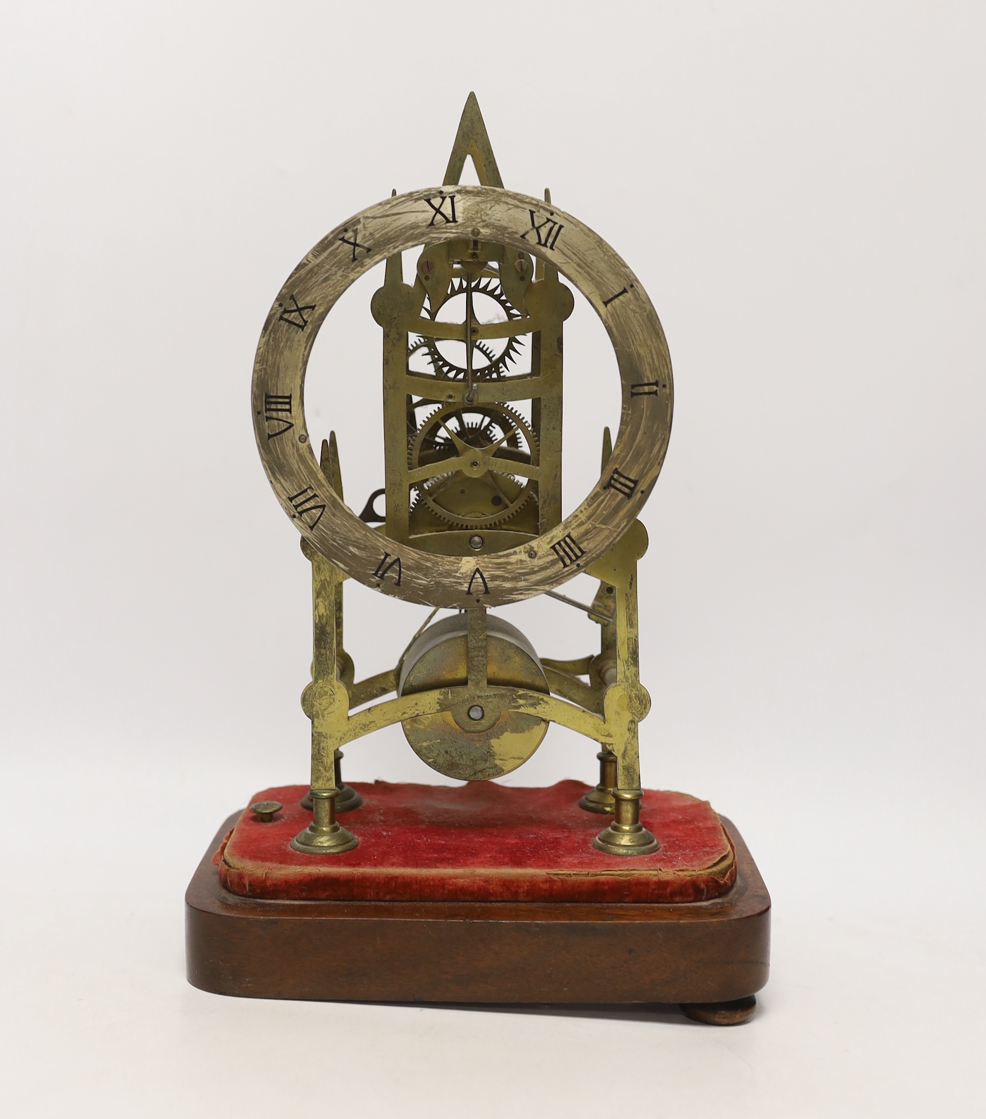 A skeleton clock with Roman numeral dial, on wooden base, 33cm high